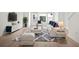 Cozy living room with modern decor featuring a white sofa, rug, console and large windows at 2511 N Grady Ave # 43, Tampa, FL 33607