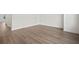 Spacious living room featuring laminate flooring, white walls, and modern trim at 2511 N Grady Ave # 43, Tampa, FL 33607