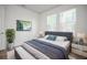 Cozy main bedroom features modern furnishings, two bright windows, and stylish decor at 2511 N Grady Ave # 43, Tampa, FL 33607