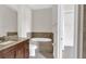 Modern bathroom featuring dual sinks, a soaking tub, and tile surround at 2627 Hancock St, Plant City, FL 33563
