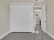 Bedroom featuring gray flooring, a closet, and entry to the hallway at 2627 Hancock St, Plant City, FL 33563