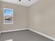 Bedroom with new gray flooring, a ceiling fan, and a bright window view at 2627 Hancock St, Plant City, FL 33563