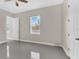 Bright bedroom featuring gray flooring, a window, and fresh paint throughout at 2627 Hancock St, Plant City, FL 33563