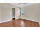 Bedroom with new wood flooring, a ceiling fan, and a bright window view at 2627 Hancock St, Plant City, FL 33563