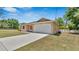 Beige single story home with an attached two car garage and a concrete driveway at 2627 Hancock St, Plant City, FL 33563