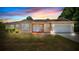 Charming single-story home boasts manicured landscaping, a two-car garage and warm exterior paint at 2627 Hancock St, Plant City, FL 33563