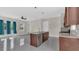 Modern kitchen featuring dark wood cabinets, stainless steel appliances, and an island with sink at 2627 Hancock St, Plant City, FL 33563