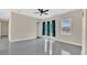 Bright living room featuring glossy floors, ceiling fan, and natural light from the sliding glass doors at 2627 Hancock St, Plant City, FL 33563