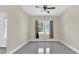 Living room featuring gray flooring, a ceiling fan, and natural light from the large window at 2627 Hancock St, Plant City, FL 33563