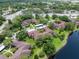 An aerial shot features multi-Gathering buildings surrounded by green spaces near a pond at 2681 Sabal Springs Cir # 204, Clearwater, FL 33761