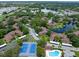 Aerial view shows a community with tennis courts, a pool, several ponds and mature trees at 2681 Sabal Springs Cir # 204, Clearwater, FL 33761