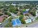 Real estate aerial showcasing tennis courts, pool, lake, and community layout at 2681 Sabal Springs Cir # 204, Clearwater, FL 33761