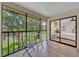 Screened in balcony with peaceful nature views, outdoor furniture, and connection to the main bedroom at 2681 Sabal Springs Cir # 204, Clearwater, FL 33761
