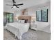 Bedroom featuring a plush bed, ceiling fan, and sliding doors to an outdoor space at 2681 Sabal Springs Cir # 204, Clearwater, FL 33761