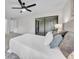 Bedroom featuring neutral tones, a ceiling fan, and access to outdoor space at 2681 Sabal Springs Cir # 204, Clearwater, FL 33761