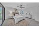 Bedroom featuring a plush bed, ceiling fan, and access to an outdoor space at 2681 Sabal Springs Cir # 204, Clearwater, FL 33761