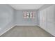 Bedroom featuring neutral walls, carpet, a large window, and white closet doors at 2681 Sabal Springs Cir # 204, Clearwater, FL 33761