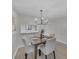 Well-lit dining area features a chandelier, view to another room, and a neutral color scheme at 2681 Sabal Springs Cir # 204, Clearwater, FL 33761
