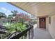View from the condo's upper level balcony with a view of lush greenery, sidewalks, and the beautiful surroundings at 2681 Sabal Springs Cir # 204, Clearwater, FL 33761