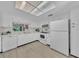 Bright kitchen with white cabinets, modern appliances, and light wood flooring at 2681 Sabal Springs Cir # 204, Clearwater, FL 33761