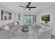 Comfortable living room featuring neutral decor, modern ceiling fan, and sliding door to the balcony at 2681 Sabal Springs Cir # 204, Clearwater, FL 33761