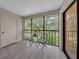 Enclosed porch with table and chairs overlooking lush trees, offering a peaceful outdoor retreat at 2681 Sabal Springs Cir # 204, Clearwater, FL 33761