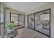 Enclosed patio with views of the bedroom and living area, featuring neutral decor and ample natural light at 2681 Sabal Springs Cir # 204, Clearwater, FL 33761
