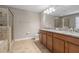 Well lit bathroom features double vanity, granite countertops, and a tiled shower and floor at 2706 Lantern Hill Ave, Brandon, FL 33511