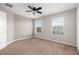 Bedroom with two windows, neutral carpet, and a ceiling fan at 2706 Lantern Hill Ave, Brandon, FL 33511