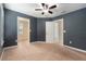 Large bedroom features neutral carpet, multiple doors, and a ceiling fan at 2706 Lantern Hill Ave, Brandon, FL 33511