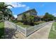 A charming two-story home is showcased from the sidewalk highlighting the yard with a classic white picket fence at 2706 Lantern Hill Ave, Brandon, FL 33511