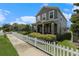 Street view showcasing a well-manicured front yard with white picket fence enhancing this two story homes curb appeal at 2706 Lantern Hill Ave, Brandon, FL 33511