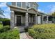 Inviting front porch featuring stone pillars and manicured landscaping, offering a warm welcome at 2706 Lantern Hill Ave, Brandon, FL 33511