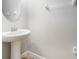 Bright half bathroom with pedestal sink and neutral wall color at 2706 Lantern Hill Ave, Brandon, FL 33511