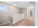 Upstairs hallway featuring neutral colors and natural light from a small window at 2706 Lantern Hill Ave, Brandon, FL 33511