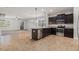 Open-concept kitchen featuring an island, stainless steel appliances, and views to living spaces at 2706 Lantern Hill Ave, Brandon, FL 33511