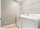 Functional laundry room with tile flooring and white washer and dryer at 2706 Lantern Hill Ave, Brandon, FL 33511