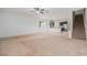Open living room with kitchen, offering a blend of carpet and tile flooring at 2706 Lantern Hill Ave, Brandon, FL 33511