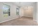 Bright living room with neutral carpet, and a large window, adjacent to the tiled foyer and a open floor plan at 2706 Lantern Hill Ave, Brandon, FL 33511