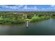 Scenic aerial view showcases a dock and gazebo on the water with lush greenery and blue sky backdrop at 2800 Coffee Pot Ne Blvd, St Petersburg, FL 33704