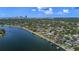 Aerial view showing neighborhood, waterfront homes with docks, and city skyline in the distance at 2800 Coffee Pot Ne Blvd, St Petersburg, FL 33704