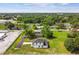 An aerial view displays this two-story home on a large lot near a wooded area and train tracks at 301 S Daniels St, Plant City, FL 33563