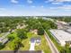 Aerial view displays two-story home with a well-manicured lawn and lush green surroundings near train tracks at 301 S Daniels St, Plant City, FL 33563