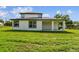 Exterior of the home features a covered patio and a large backyard at 301 S Daniels St, Plant City, FL 33563