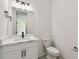Stylish bathroom with a sink, vanity, mirror, modern lighting, and a toilet at 301 S Daniels St, Plant City, FL 33563