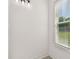 Bright bathroom featuring a window with blinds, light gray walls and a vanity with three lights at 301 S Daniels St, Plant City, FL 33563