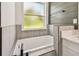 Well-lit bathroom with modern fixtures, including a soaking tub and a bright window at 301 S Daniels St, Plant City, FL 33563