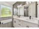 Elegant bathroom featuring double sinks, modern fixtures, and a large framed window at 301 S Daniels St, Plant City, FL 33563