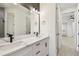 Modern bathroom boasts double sinks, framed mirror and view to bedroom hallway at 301 S Daniels St, Plant City, FL 33563