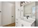 Bathroom featuring a vanity with white countertop, modern fixtures, and a decorative mirror at 301 S Daniels St, Plant City, FL 33563